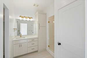 Full bath with vanity, a shower stall, visible vents, and tile patterned floors