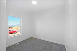 Carpeted empty room featuring visible vents and baseboards