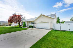 Ranch-style house featuring fence, a garage, concrete driveway, a porch, and a gate