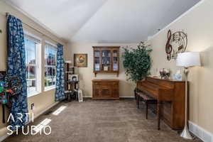 Living area with baseboards, carpet flooring, visible vents, and vaulted ceiling