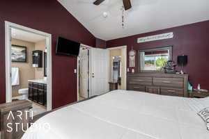 Bedroom with lofted ceiling, ceiling fan, ensuite bath, and visible vents