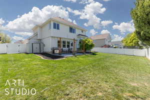 Rear view of house featuring a yard, a patio area, a fenced backyard, and a gate