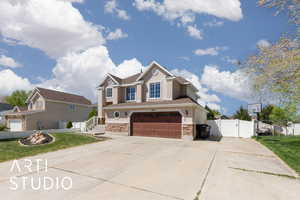 Craftsman-style house with driveway, fence, an attached garage, stucco siding, and a gate