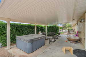 View of patio / terrace with a hot tub