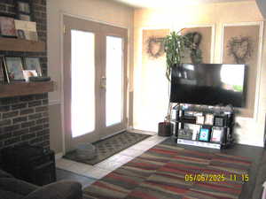 Tiled entryway with french doors and plenty of natural light