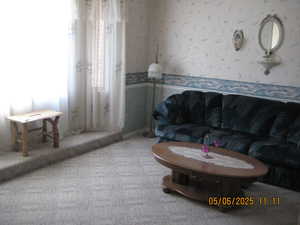 Carpeted living room featuring wallpapered walls