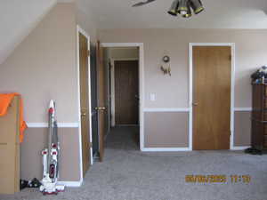 Unfurnished bedroom with baseboards and carpet floors