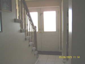 Entryway featuring stairway and tile patterned floors