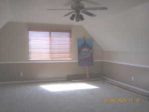 Bonus room featuring vaulted ceiling, ceiling fan, carpet flooring, and baseboards