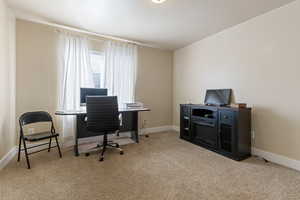 Carpeted office space with baseboards