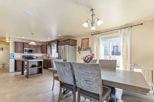 Dining space featuring recessed lighting, light tile patterned flooring, and a notable chandelier