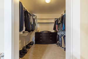Walk in closet with carpet flooring
