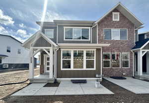 View of front facade featuring board and batten siding and brick siding