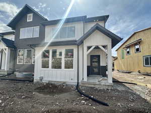 Back of property with board and batten siding and brick siding