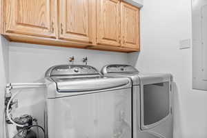 Laundry area with washing machine and clothes dryer and cabinet space