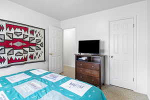 Bedroom featuring a textured ceiling, baseboards, and carpet floors
