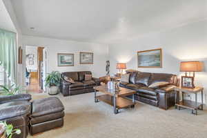 Living area with a textured ceiling and carpet floors