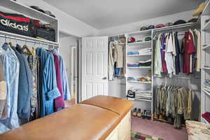 Spacious closet featuring carpet flooring