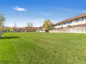 View of yard with fence and a residential view
