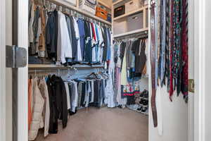 Walk in closet featuring carpet flooring