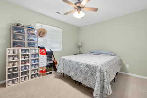 Bedroom with ceiling fan, carpet floors, baseboards, and visible vents