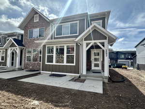 View of front facade with board and batten siding and brick siding