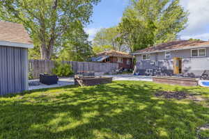 View of yard with a patio area and fence