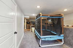 Carpeted bedroom featuring visible vents and recessed lighting