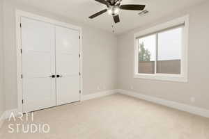 Unfurnished bedroom featuring light colored carpet, baseboards, a closet, and a ceiling fan