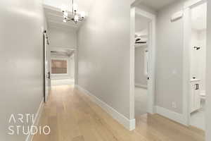Corridor with light wood finished floors and baseboards