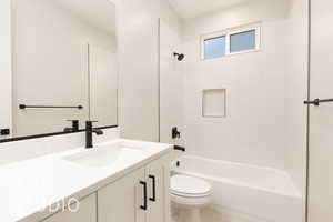 Bathroom with toilet, vanity, and shower / bath combination