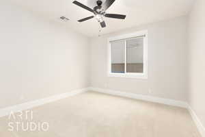 Empty room with carpet floors, baseboards, and a ceiling fan