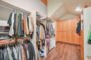 Spacious closet featuring lofted ceiling and wood finished floors