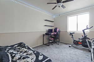 Bedroom featuring carpet flooring and baseboards