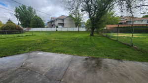 View of yard with a patio area and fence