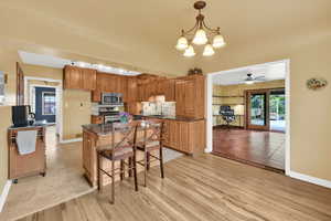 Kitchen with baseboards, appliances with stainless steel finishes, a sink, and a kitchen island