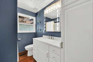 Full bathroom with toilet, visible vents, curtained shower, tile patterned floors, and vanity