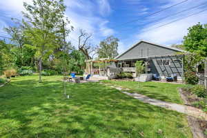 View of yard featuring a pergola, an outdoor fire pit, a deck, and a patio