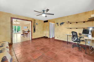 Office space featuring ceiling fan, baseboards, visible vents, and tile patterned flooring