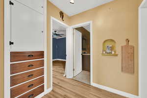 Hallway with light wood finished floors and baseboards