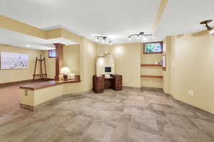 Interior space featuring baseboards and stone finish flooring