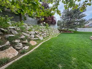 View of yard featuring fence