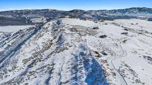 Snowy aerial view featuring a mountain view