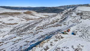 Snowy aerial view featuring a mountain view