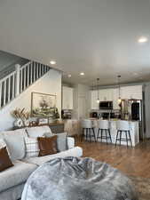 Living area with wood finished floors and recessed lighting