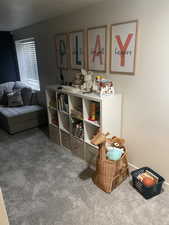 Recreation room with carpet flooring and baseboards