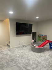 Playroom with carpet floors, baseboards, and recessed lighting
