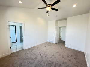 Unfurnished bedroom featuring lofted ceiling, baseboards, visible vents, and carpet