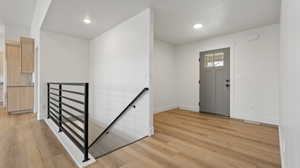 Entryway featuring baseboards, recessed lighting, light wood-style floors, and visible vents