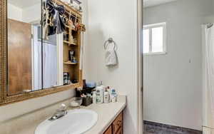 Full bathroom featuring tile patterned floors and vanity